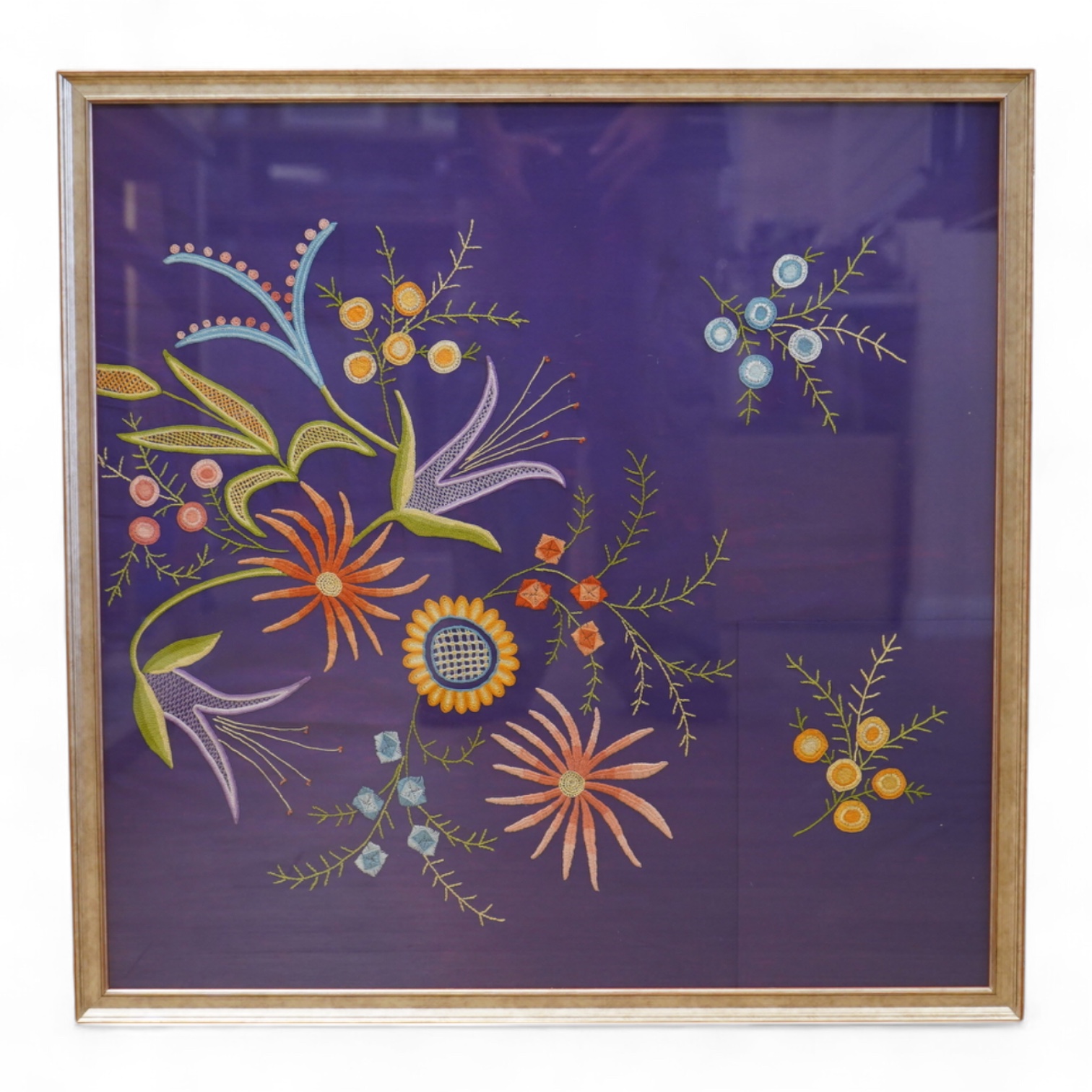A framed modern silk floral embroidered panel on purple background. 62cm x 63cm